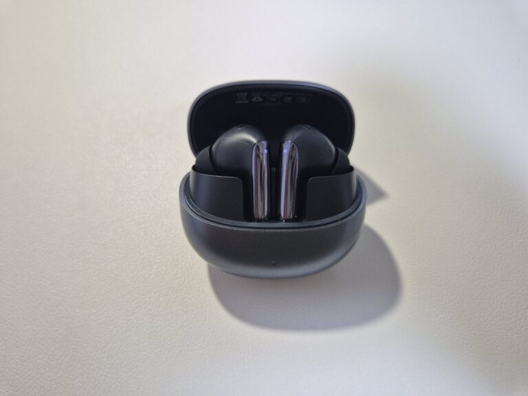 QCY 멜로버즈 프로 플러스 이어폰이 열린 충전 케이스 안에 들어 있는 모습